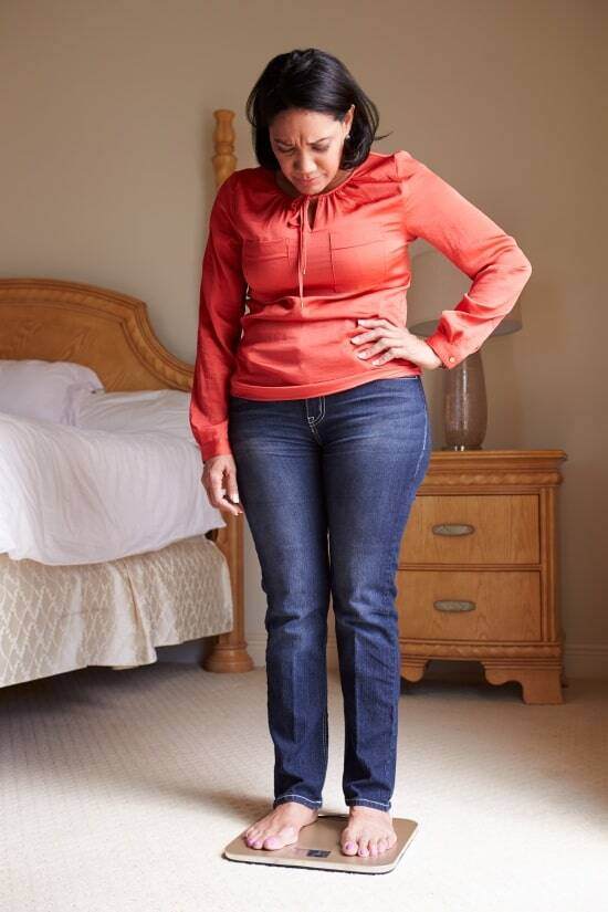 senior-woman-looking-at-scale